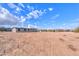 Mobile home on a desert lot with a large yard and distant mountains at 645 S Warren Rd, Maricopa, AZ 85139