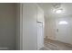 Clean hallway with light walls and wood-look flooring at 645 S Warren Rd, Maricopa, AZ 85139