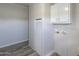 Bright laundry room with white cabinets and vinyl flooring at 645 S Warren Rd, Maricopa, AZ 85139