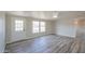 Living room with wood-look floors and door to outside at 645 S Warren Rd, Maricopa, AZ 85139