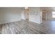 Living room with wood-look floors and neutral walls at 645 S Warren Rd, Maricopa, AZ 85139