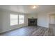 Living room with a stone fireplace and wood-look flooring at 645 S Warren Rd, Maricopa, AZ 85139