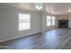 Spacious living room featuring a corner fireplace and large windows at 645 S Warren Rd, Maricopa, AZ 85139