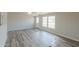 Living room with wood-look floors and large windows at 645 S Warren Rd, Maricopa, AZ 85139