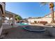 Spacious backyard with a pool, trampoline, and patio area at 6970 W Morning Dove Dr, Glendale, AZ 85308