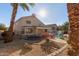 Large backyard with a pool, trampoline, and palm trees at 6970 W Morning Dove Dr, Glendale, AZ 85308