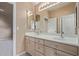 Double vanity bathroom with a large mirror and tile flooring at 6970 W Morning Dove Dr, Glendale, AZ 85308