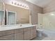 Bathroom boasts a vanity with double sinks and a bathtub at 6970 W Morning Dove Dr, Glendale, AZ 85308