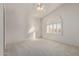 Well-lit bedroom featuring a ceiling fan and arched window at 6970 W Morning Dove Dr, Glendale, AZ 85308