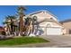 Two-story house with a white garage door and palm trees at 6970 W Morning Dove Dr, Glendale, AZ 85308