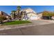 Two-story house with a large driveway and lush landscaping at 6970 W Morning Dove Dr, Glendale, AZ 85308