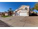 Tan two-story house with a white garage door and gravel landscaping at 6970 W Morning Dove Dr, Glendale, AZ 85308