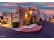 Building exterior at dusk with stairs and garage at 7021 E Earll Dr # 213, Scottsdale, AZ 85251