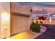 Attached garage with exterior lighting at dusk at 7021 E Earll Dr # 213, Scottsdale, AZ 85251