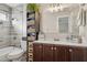 Bathroom with dark brown vanity, large mirror, and tiled shower/tub at 7215 W Mclellan Rd, Glendale, AZ 85303