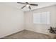 Bright bedroom with carpeted floor, window blinds, and ceiling fan at 7215 W Mclellan Rd, Glendale, AZ 85303