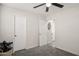 Bedroom with carpet, door to bathroom, and ceiling fan at 7215 W Mclellan Rd, Glendale, AZ 85303