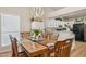 Bright dining room with a wooden table and chairs, near kitchen at 7215 W Mclellan Rd, Glendale, AZ 85303