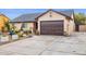 House exterior with a large driveway and well-maintained landscaping at 7215 W Mclellan Rd, Glendale, AZ 85303