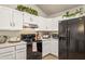 Well-equipped kitchen boasts white cabinets and black appliances at 7215 W Mclellan Rd, Glendale, AZ 85303