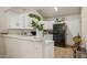 Bright eat-in kitchen with white cabinets, black appliances, and ample counter space at 7215 W Mclellan Rd, Glendale, AZ 85303