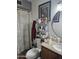 Well-lit bathroom with shower and granite countertop at 7940 W Avalon Dr, Phoenix, AZ 85033