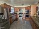 Spacious kitchen with stainless steel appliances and granite countertops at 7940 W Avalon Dr, Phoenix, AZ 85033