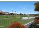 Backyard view of a community with a pond, walking path, and manicured lawns at 8245 E Jenan Dr, Scottsdale, AZ 85260