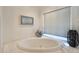 Bathroom featuring a corner soaking tub and window at 8245 E Jenan Dr, Scottsdale, AZ 85260