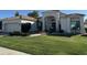 White stucco home with tile roof, lush lawn, and mature landscaping at 8245 E Jenan Dr, Scottsdale, AZ 85260