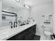 Modern bathroom with double vanity and black cabinets at 8314 E Clarendon Ave, Scottsdale, AZ 85251