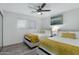 Guest bedroom with two twin beds and yellow blanket at 8314 E Clarendon Ave, Scottsdale, AZ 85251