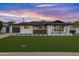 Beautiful mid-century modern home with a renovated exterior and landscaped lawn at 8314 E Clarendon Ave, Scottsdale, AZ 85251