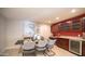 Elegant dining area with a wine cooler and red accent wall at 8514 E Fairmount Ave, Scottsdale, AZ 85251