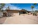 House exterior showcasing a two-car garage and a landscaped front yard at 8514 E Fairmount Ave, Scottsdale, AZ 85251