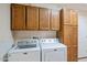 Laundry room with Maytag washer and dryer, and ample cabinetry at 8514 E Fairmount Ave, Scottsdale, AZ 85251