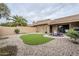 Landscaped backyard with artificial turf and gravel at 9103 E Winchcomb Dr, Scottsdale, AZ 85260