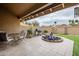 Relaxing patio with seating area, grill, and fountain feature at 9103 E Winchcomb Dr, Scottsdale, AZ 85260