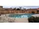 Community pool with lounge chairs and shaded seating area at 9103 E Winchcomb Dr, Scottsdale, AZ 85260