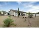 Landscaped backyard with gravel, cacti and covered patio at 9546 E Anasazi Pl, Gold Canyon, AZ 85118