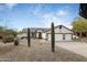 Two-car garage and xeriscaped front yard with rock and cacti at 9546 E Anasazi Pl, Gold Canyon, AZ 85118