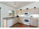 Kitchen features light wood cabinets, white appliances, and granite countertops at 9546 E Anasazi Pl, Gold Canyon, AZ 85118