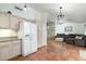 Open kitchen with white appliances and view into living room at 9546 E Anasazi Pl, Gold Canyon, AZ 85118