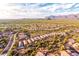 Aerial view of a residential area boasting mountain views and community pool at 9900 E Desert Trail Ln, Gold Canyon, AZ 85118