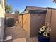 Backyard featuring an AC unit, a storage shed, gravel, and flower decorations at 9900 E Desert Trail Ln, Gold Canyon, AZ 85118