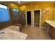 Well-lit bathroom featuring a glass-enclosed shower and separate soaking tub at 9900 E Desert Trail Ln, Gold Canyon, AZ 85118