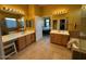 Bright bathroom featuring double sinks, tile floors, and a doorway to the bedroom at 9900 E Desert Trail Ln, Gold Canyon, AZ 85118