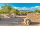 Scenic entry with stone features amidst lush desert landscape and mountain views at 9900 E Desert Trail Ln, Gold Canyon, AZ 85118