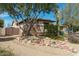 Close-up of a charming home featuring a desert landscape, and a mix of stucco and brick exterior at 9900 E Desert Trail Ln, Gold Canyon, AZ 85118