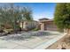 Lovely single-story home with desert landscaping, a two-car garage, and an extended driveway at 9900 E Desert Trail Ln, Gold Canyon, AZ 85118